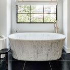 Calma Bathtub carved from  a solid block of carrara marbl
