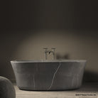 Calma Bathtub carved from  a solid block of marquina taupe marble with a honed finish