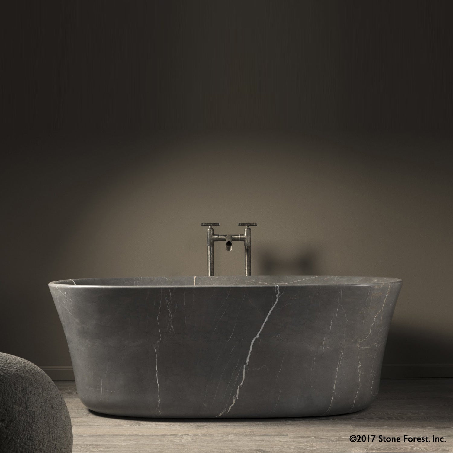 Calma Bathtub carved from  a solid block of marquina taupe marble with a honed finish