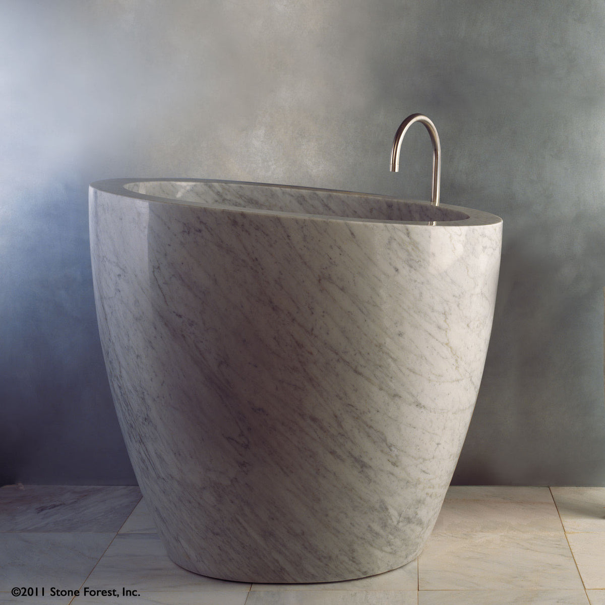The free standing Stone Forest Eau Soaking Bathtub is hand-carved from a solid block of Carrara marble. Made on a custom basis. image 1 of 2