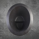 Top View dark gray, honed basalt soaking tub with a smooth finish and rounded contours, placed on a light gray floor.