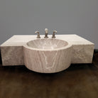 A custom vanity in Siena Silver Gray Marble featuring an integral sink