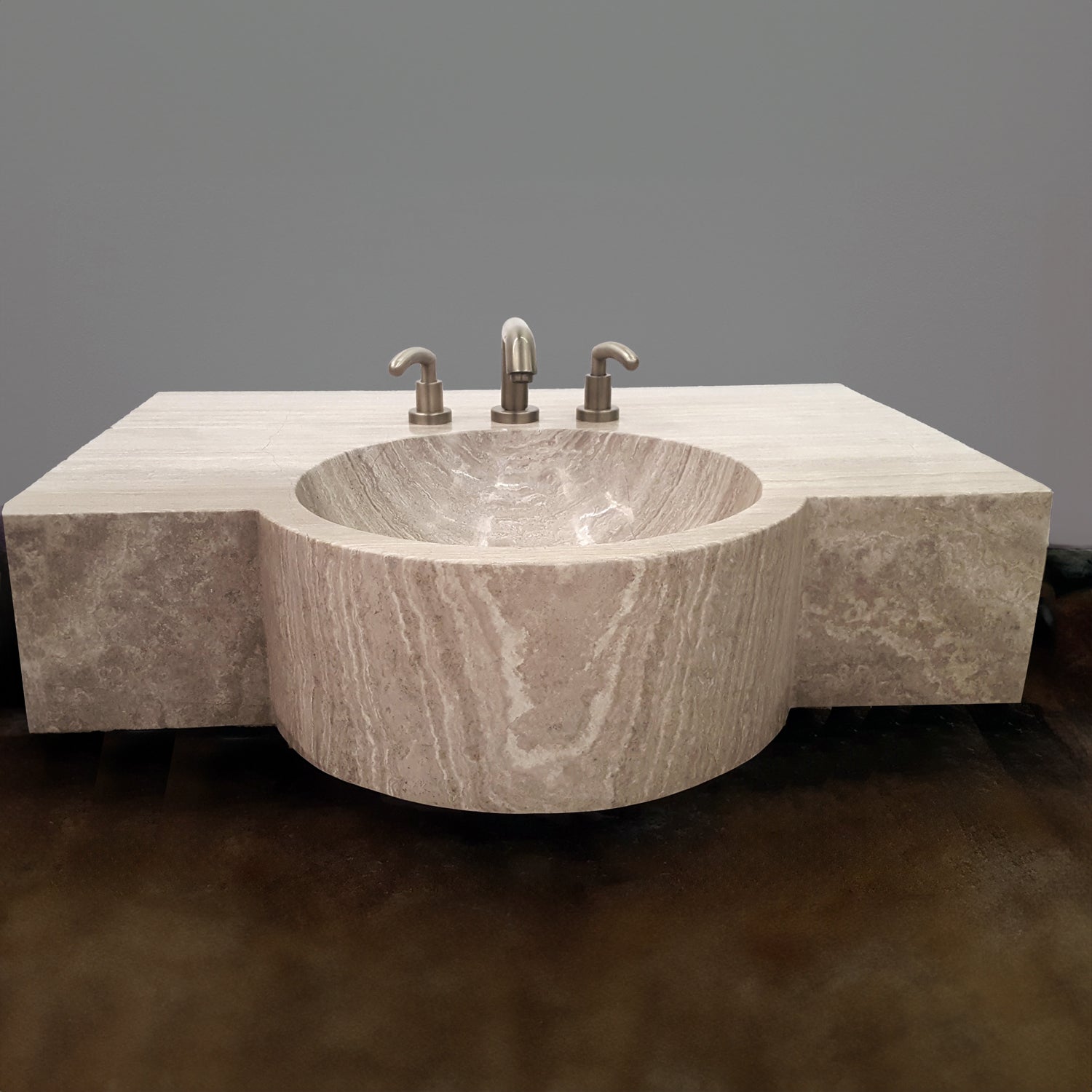 A custom vanity in Siena Silver Gray Marble featuring an integral sink