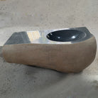 A custom boulder sink with a smooth finish and an oval integral sink.