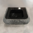 Custom Lavatory Vanity carved from black granite with rough chiseled exterior