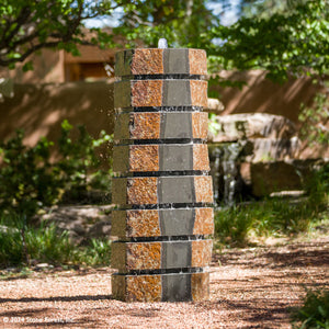 Made from Natural Basalt Columns with contrasting polished black and natural stone crust surfaces.  Basalt in its raw form is a deep charcoal black. The exterior of these columns is weathered with time and exposure. For sculptural appeal we add horizontal saw cuts at intervals of 6” throughout the form image 1 of 2