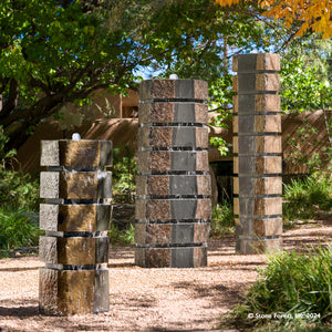Made from Natural Basalt Columns with contrasting polished black and natural stone crust surfaces.  Basalt in its raw form is a deep charcoal black. The exterior of these columns is weathered with time and exposure. For sculptural appeal we add horizontal saw cuts at intervals of 6” throughout the form image 2 of 2