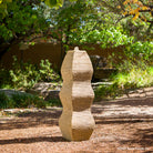 The Wave Fountain sculpted from a block of beige granite.