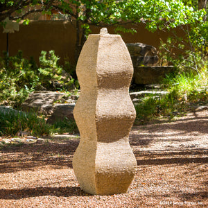 The Wave Fountain sculpted from a block of beige granite. image 3 of 5