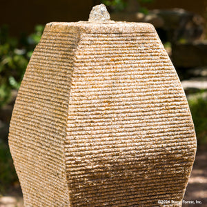 The Wave Fountain sculpted from a block of beige granite. image 5 of 5