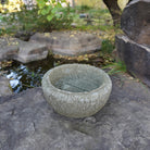 Lotus Basin is carved from Verde Basalt, featuring Buddha Feet details carved into the bottom of the basin.