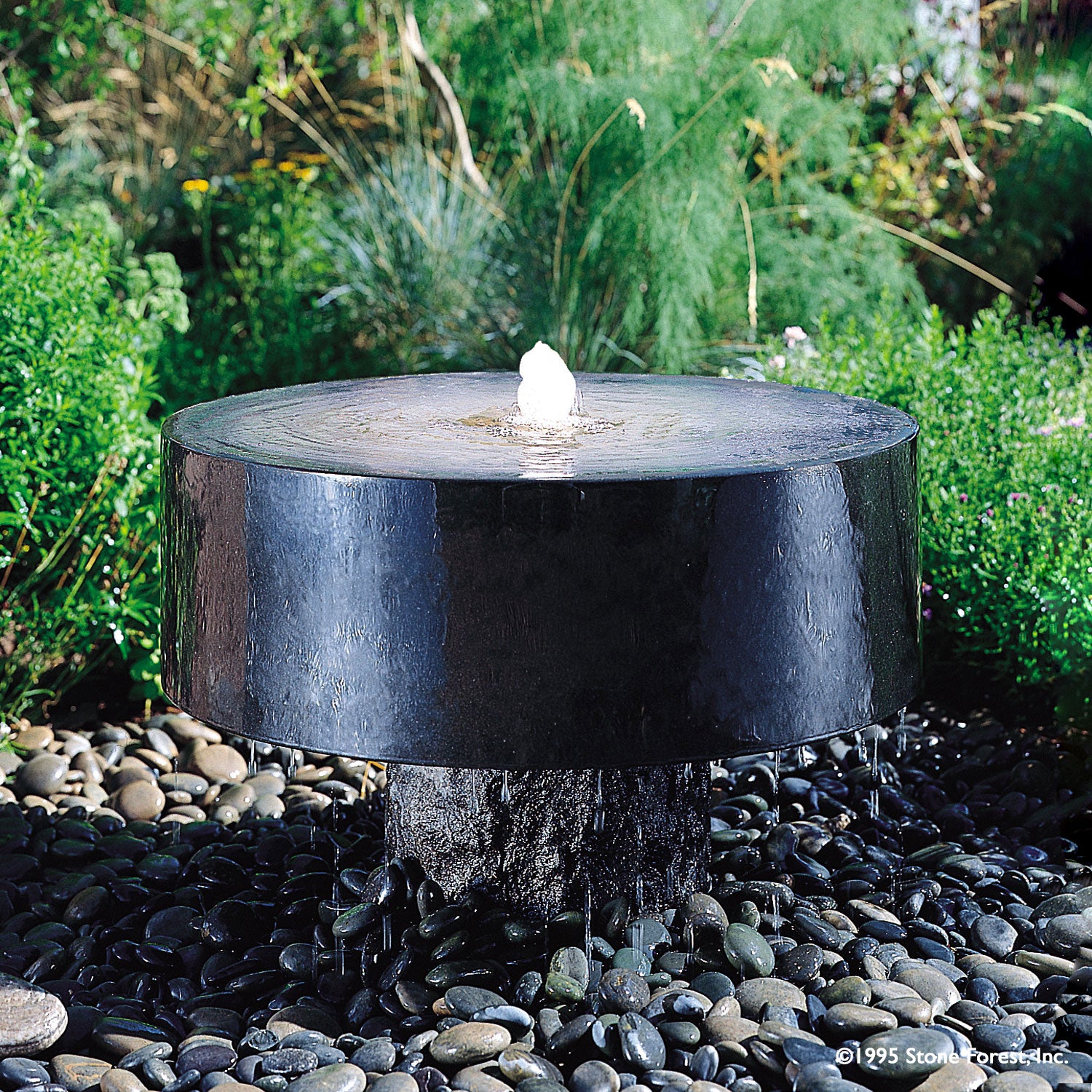 Stone Forest Polished Millstone garden fountain carved from black granite