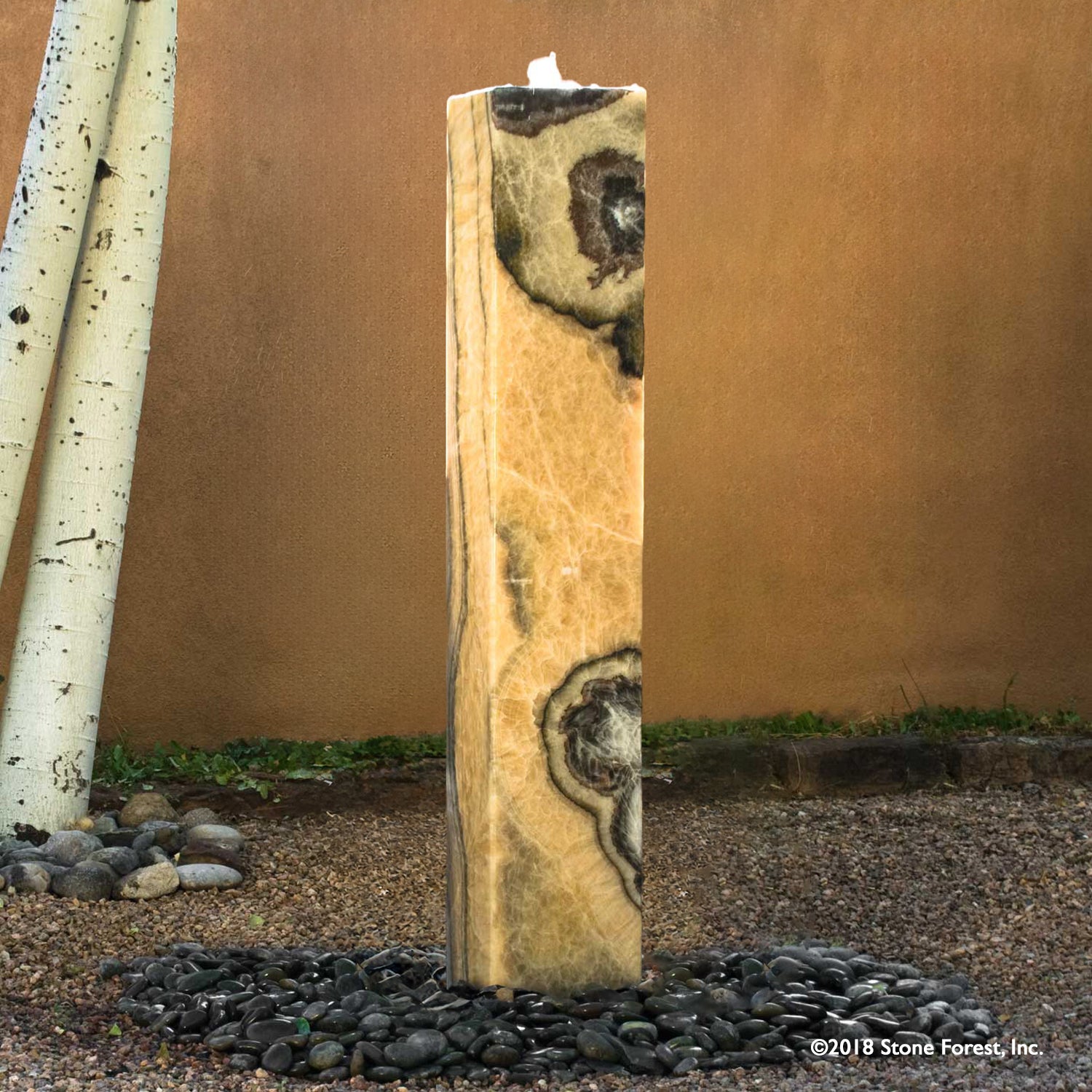 Plinth garden fountain carved from multi-colored onyx 