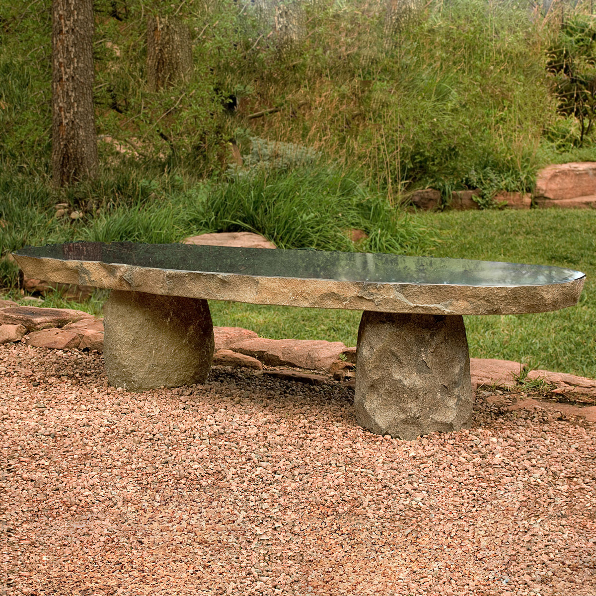 Stone Forest Natural Boulder Slab Bench carved from black granite boulders in natural setting image 1 of 1
