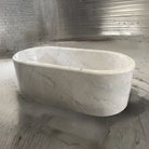 A white Carrara marble racetrack bathtub.