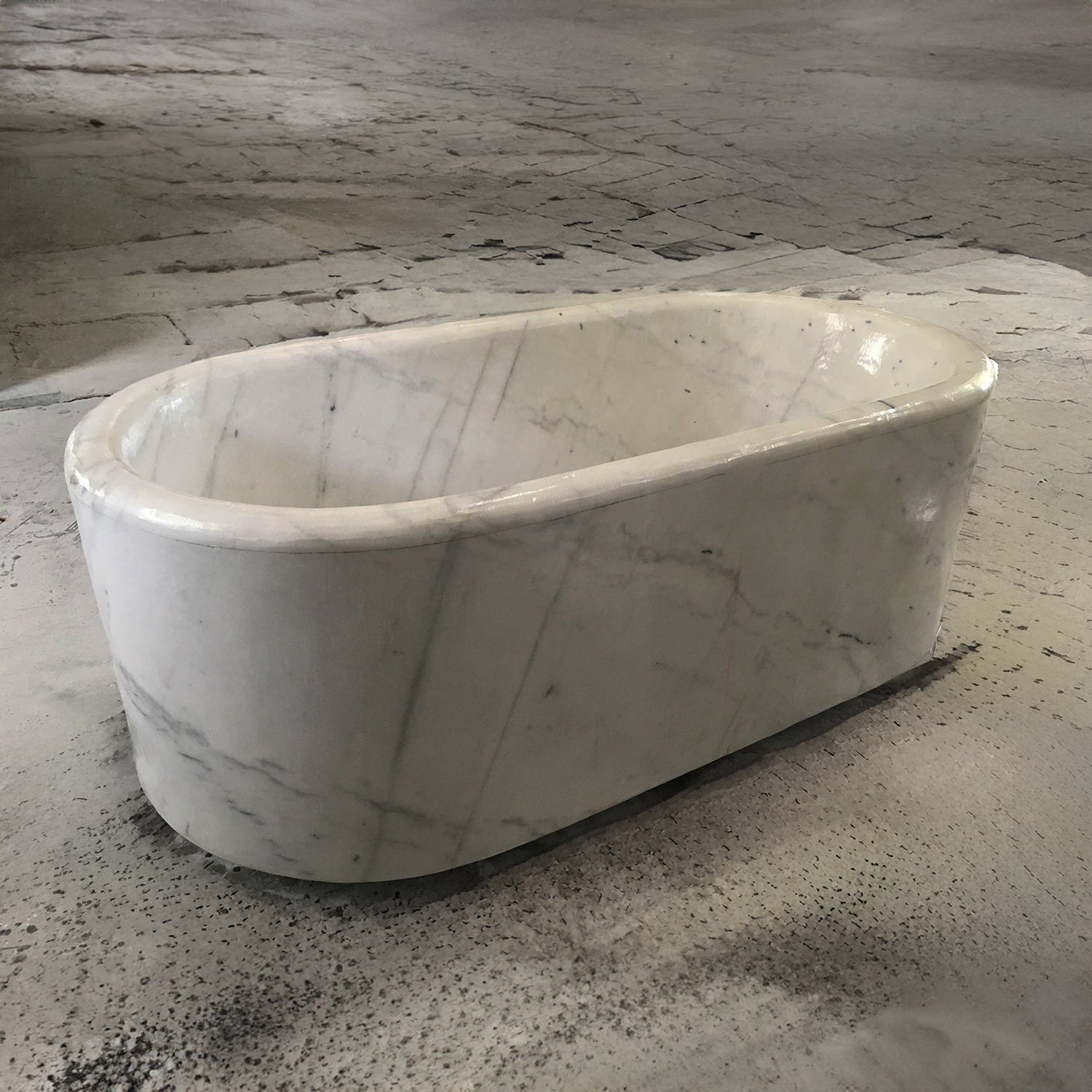 A white Carrara marble racetrack bathtub.