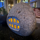 Ishi Lantern with light showing stone carved  window side 