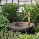 Stone Forest Wabi Basin used as garden fountain with bamboo spout - Hand carved from granite