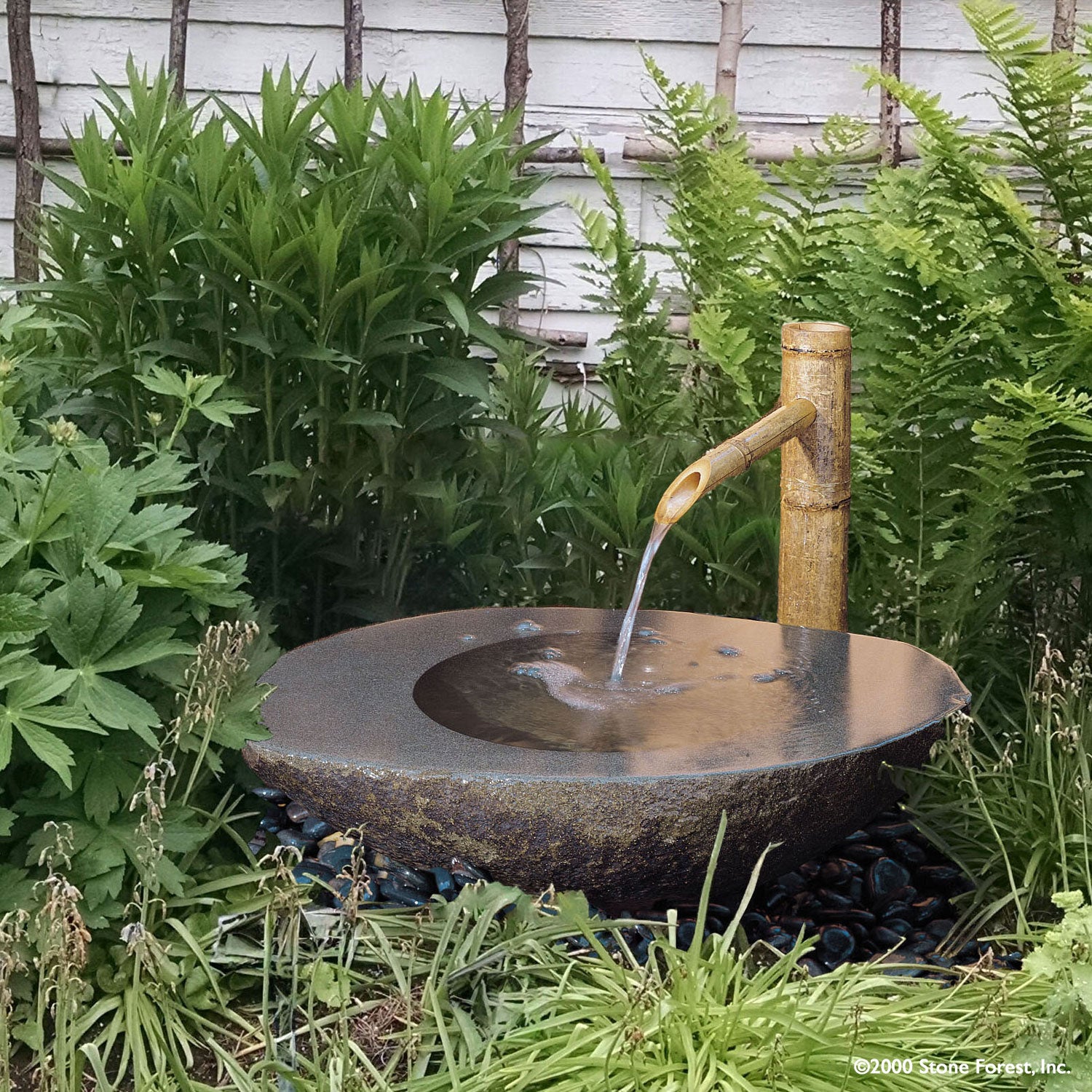 Stone Forest Wabi Basin used as garden fountain with bamboo spout - Hand carved from granite