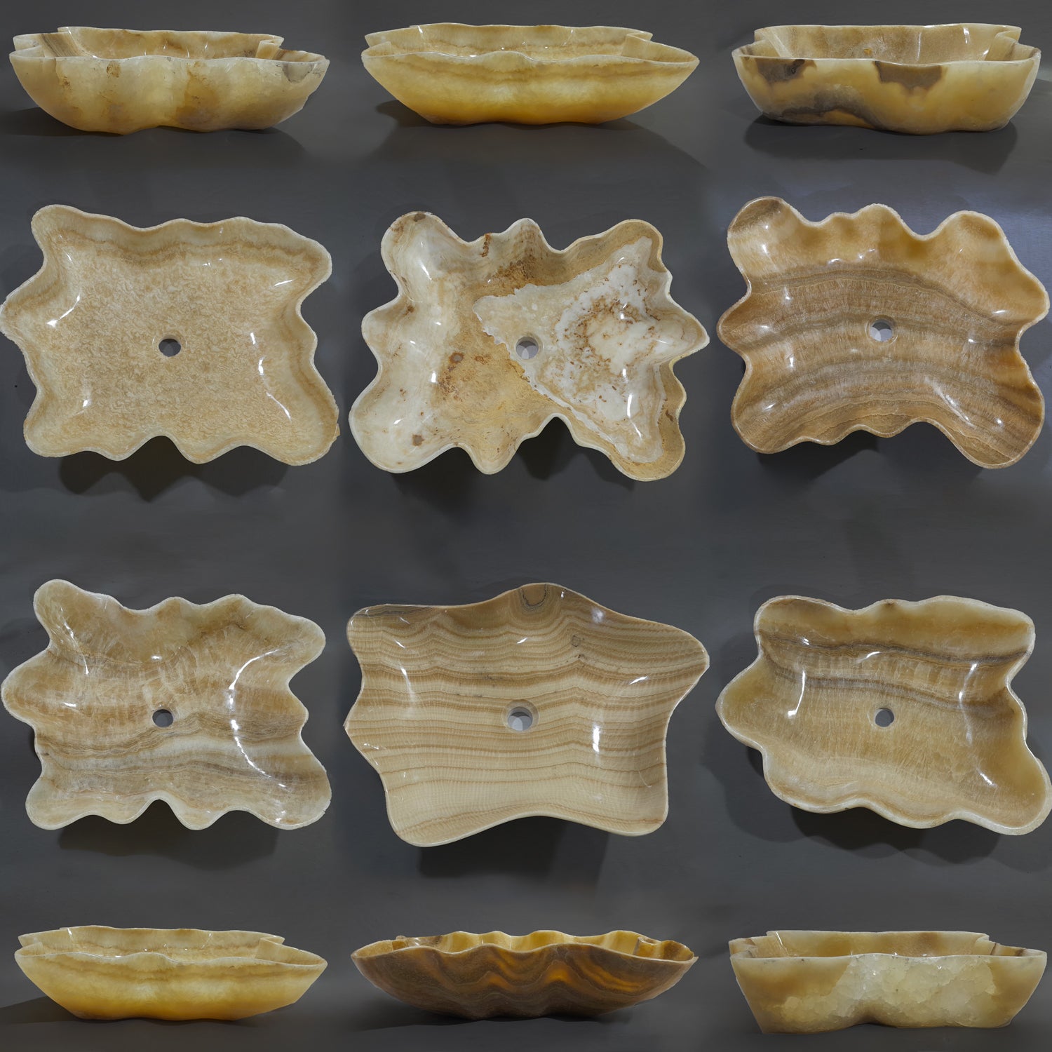 Collection of Onyx bath sinks with natural patterns on a dark background