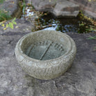 Lotus Basin is carved from Verde Basalt, featuring Buddha Feet details carved into the bottom of the basin.