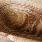 Detail of a large, oval-shaped, multi-color onyx planter