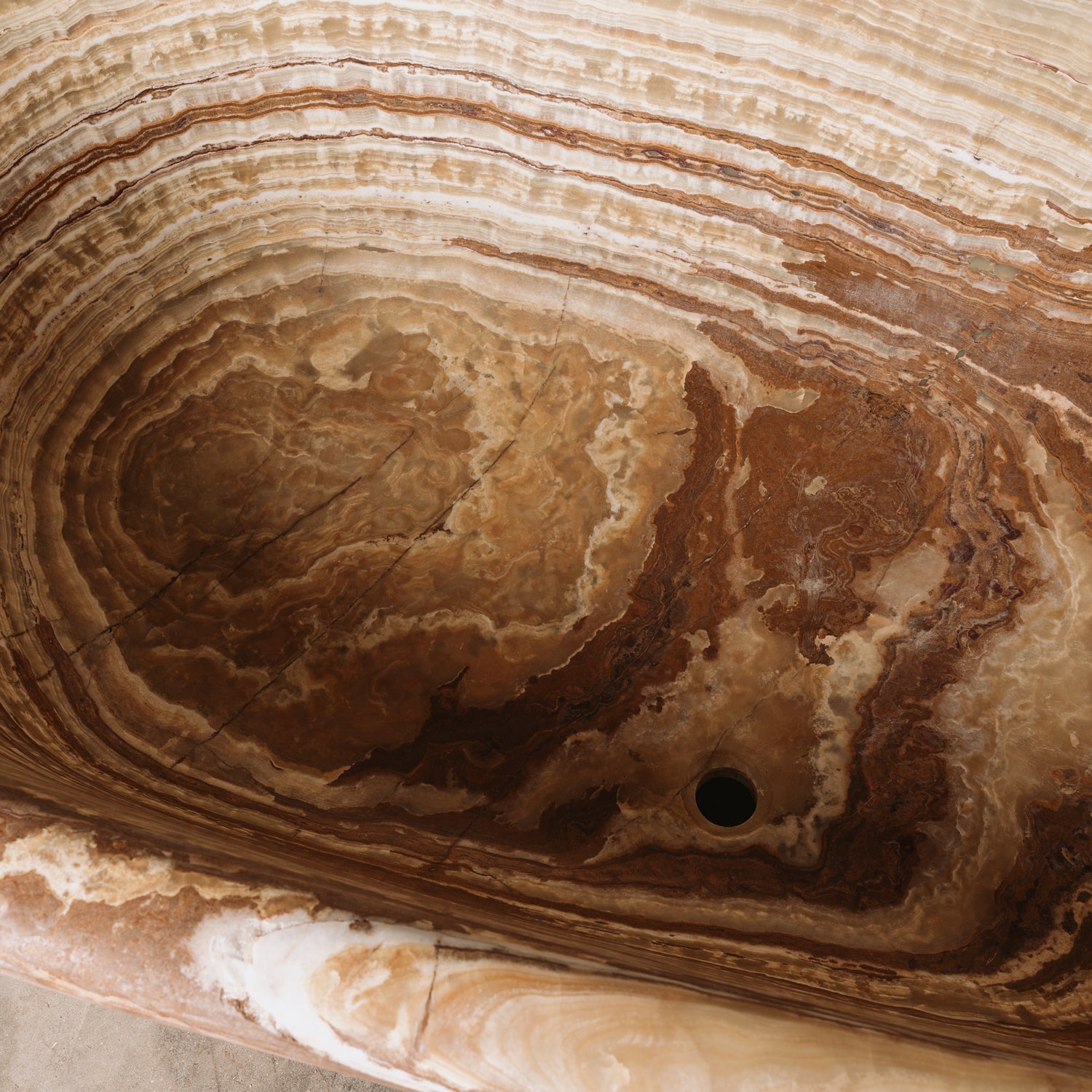 Detail of a large, oval-shaped, multi-color onyx planter