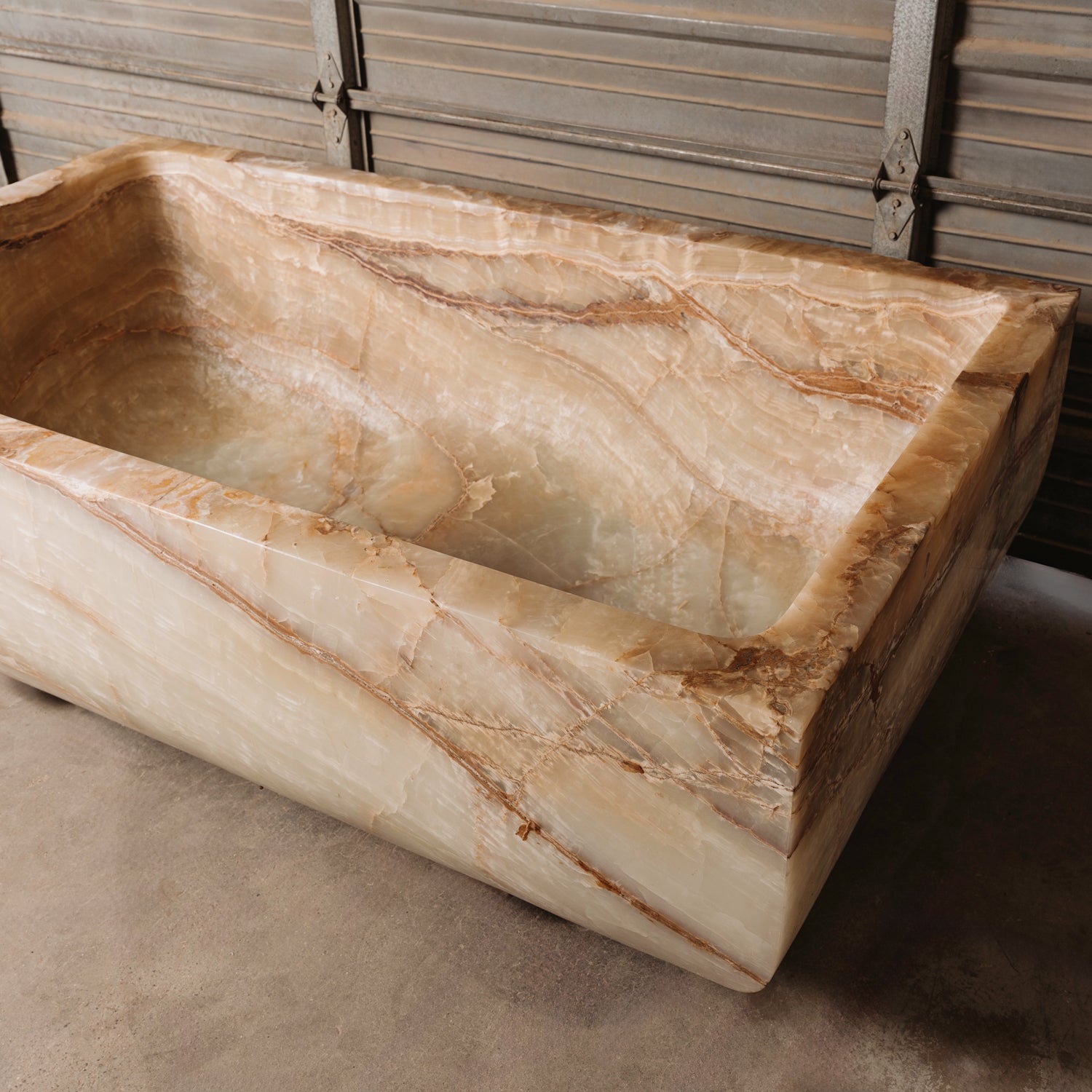 A large, rectangular onyx trough planter with multi-color patterns, displayed indoors.