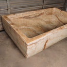 A large, rectangular onyx trough planter with multi-color patterns, displayed indoors.