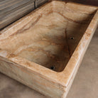 A large, rectangular onyx trough planter with multi-color patterns, displayed indoors.