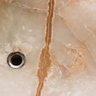 Detail of a large, rectangular onyx trough planter with multi-color patterns, 