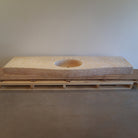 A beige marble vanity with carved details