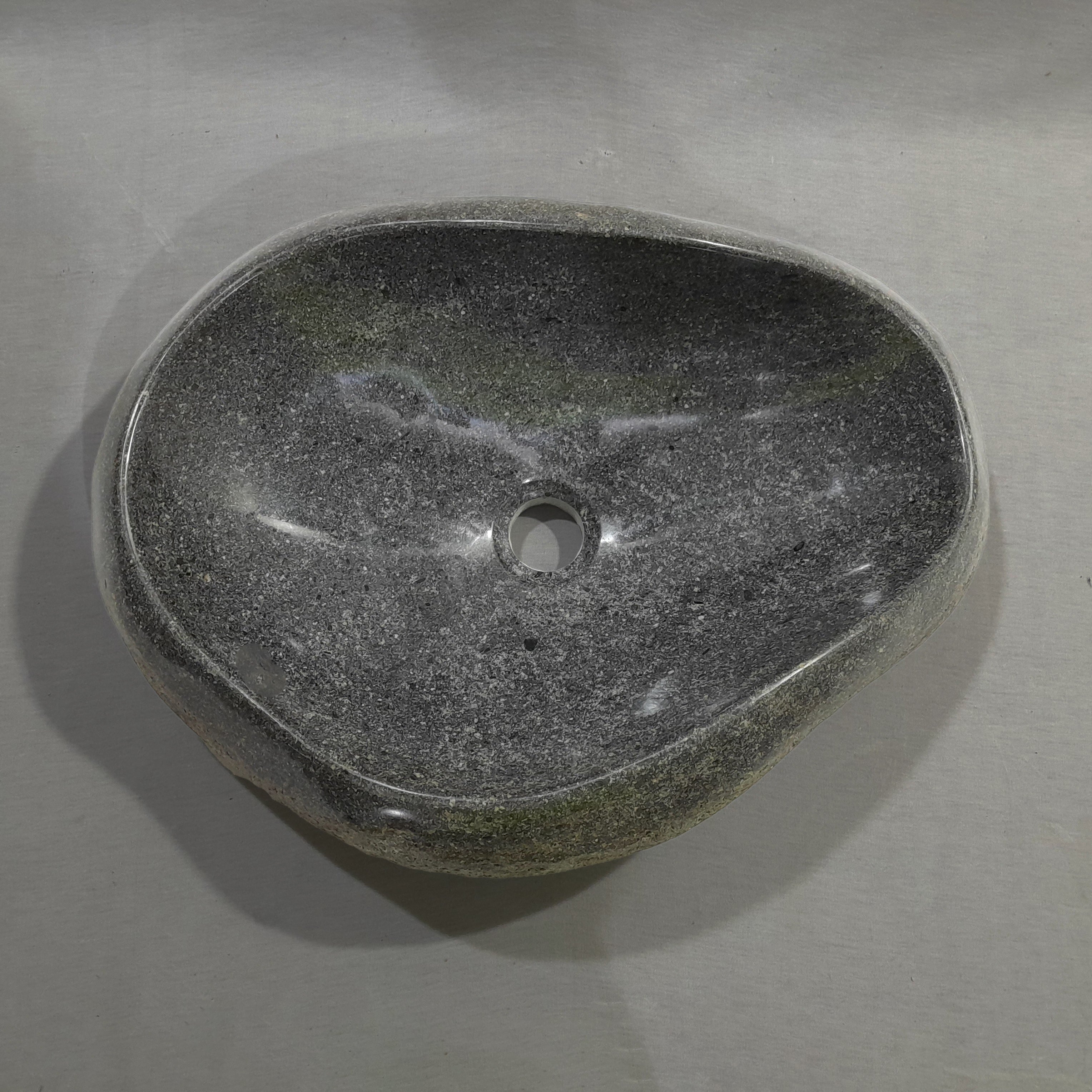 Natural stone sink on a gray background