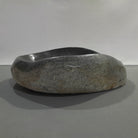 Natural stone sink on a gray background