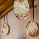 These gallery-worthy hanging sculptures are carved from blocks of premium multi-color onyx with a high-polish finish and feature a crescent design on one side.