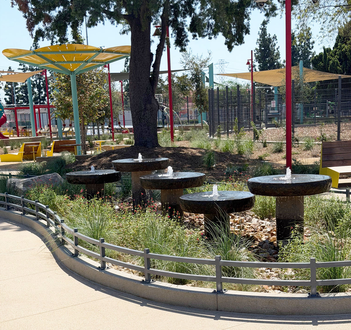 Five Custom natural millstones in different heights, set in park landscape