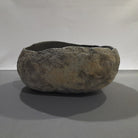 Natural stone sink on a gray background