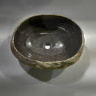 Natural stone sink on a gray background