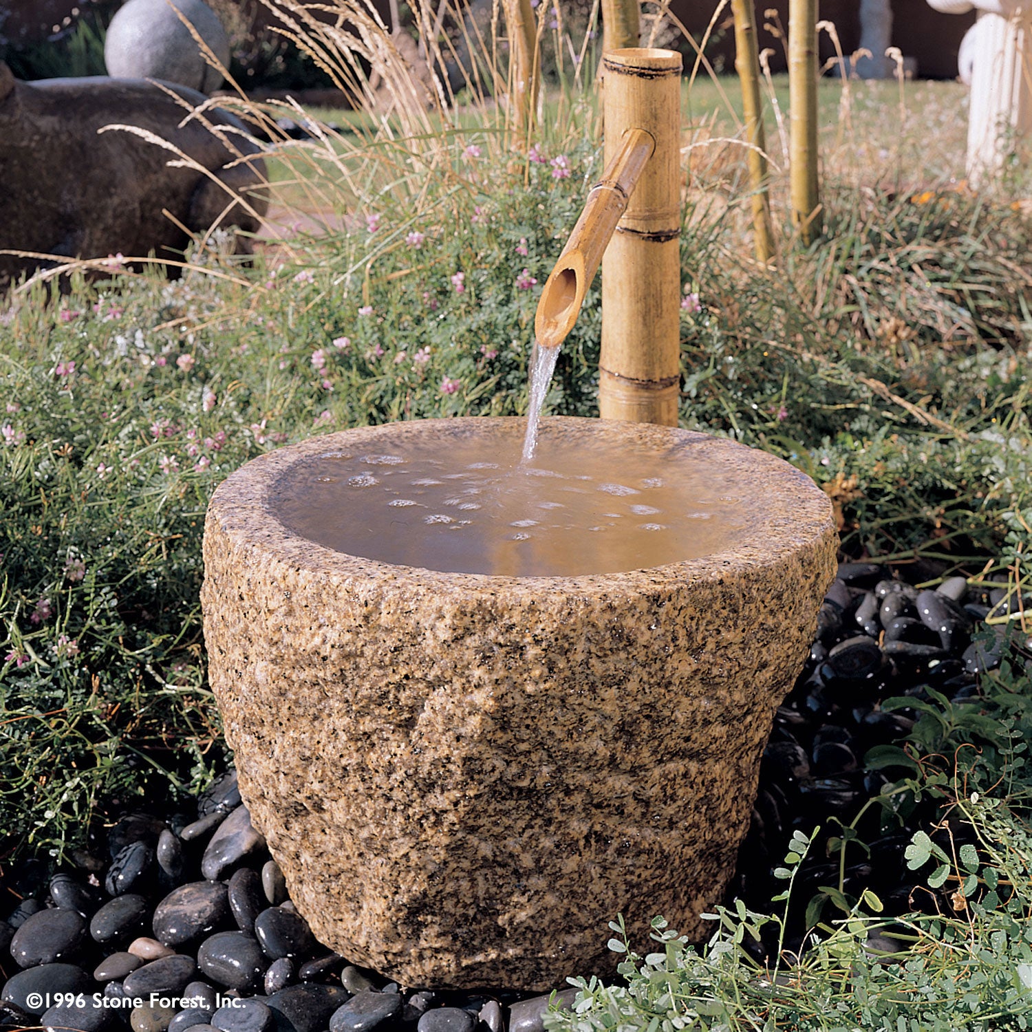Stone Forest Rough Vessel carved from beige granite, used as a garden fountain. Can also be used as a Tsukubai