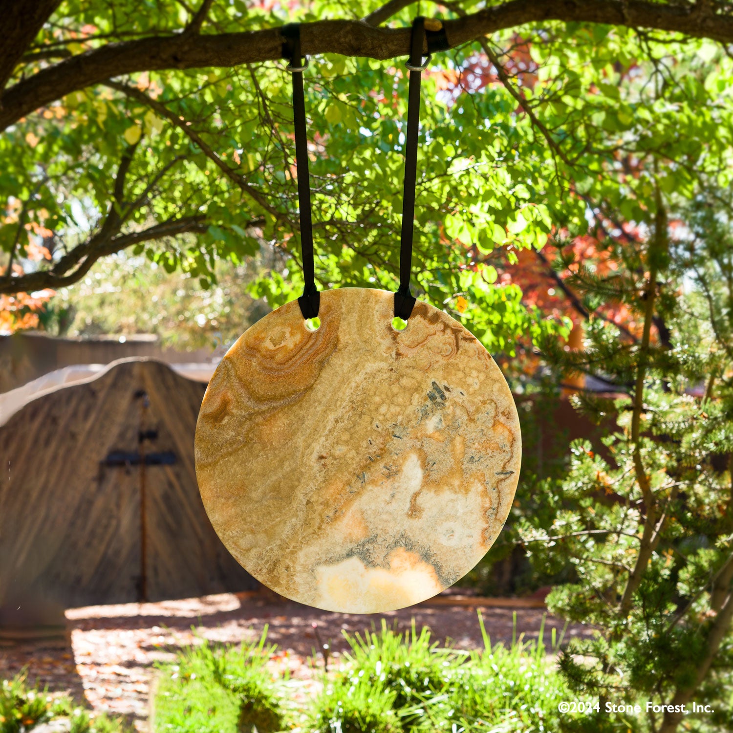Gallery-worthy hanging sculptures carved from blocks of beige onyx with a convex surface and honed finish.  Installed using a suspension strap.