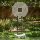 Gallery-worthy sculpture, ancient/contemporary. The hand-carved blue-gray granite pendant features a ribbed pattern on both surfaces and can be used indoors or outdoors, supported by an iron stand.