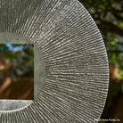 Gallery-worthy sculpture, ancient/contemporary. The hand-carved blue-gray granite pendant features a ribbed pattern on both surfaces and can be used indoors or outdoors, supported by an iron stand.