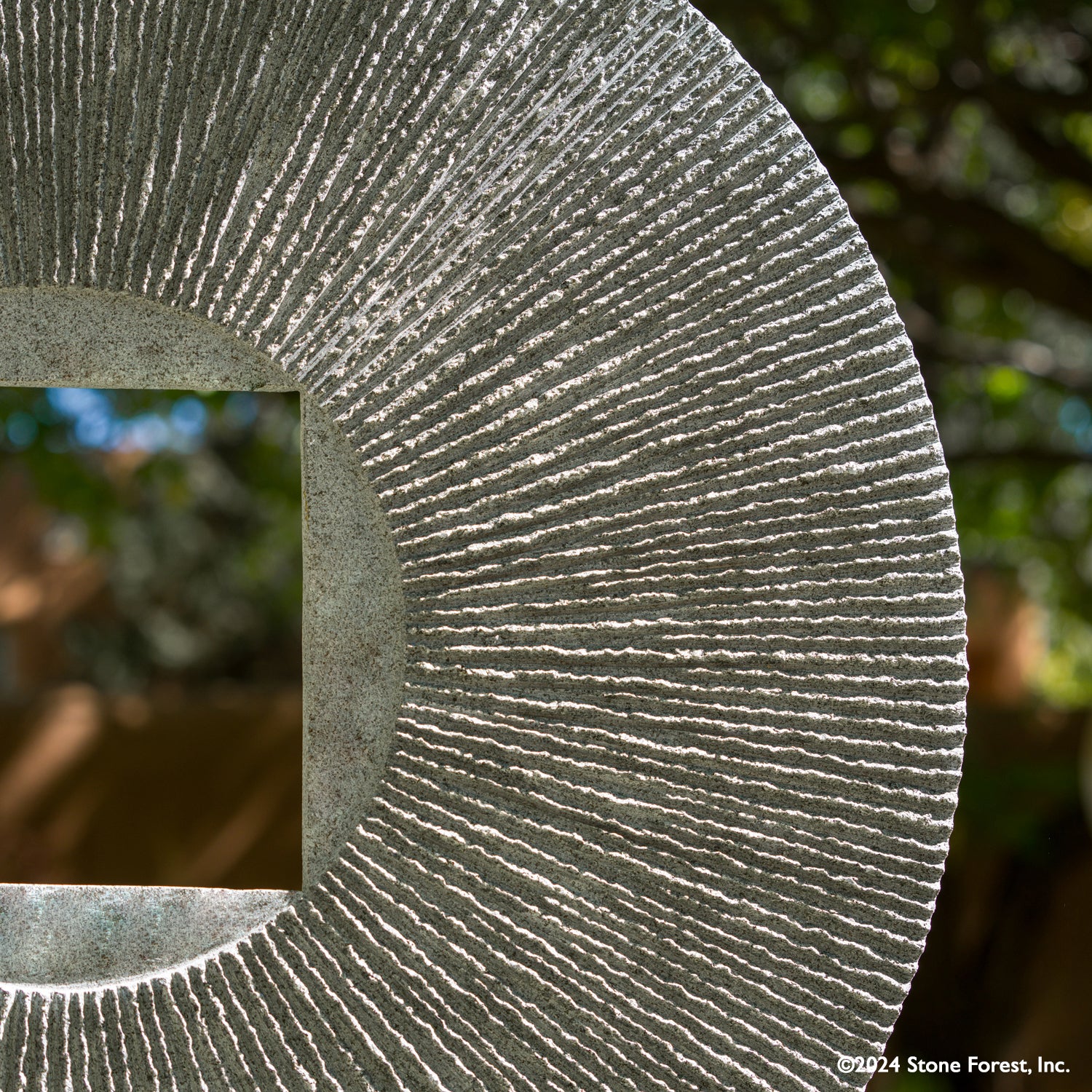 Gallery-worthy sculpture, ancient/contemporary. The hand-carved blue-gray granite pendant features a ribbed pattern on both surfaces and can be used indoors or outdoors, supported by an iron stand.