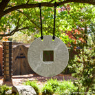 Gallery-worthy sculpture, ancient/contemporary. The hand-carved blue-gray granite pendant features a ribbed pattern on both surfaces and can be used indoors or outdoors, supported by an iron stand.