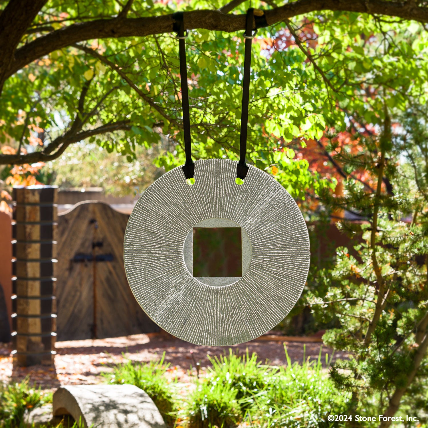 Gallery-worthy sculpture, ancient/contemporary. The hand-carved blue-gray granite pendant features a ribbed pattern on both surfaces and can be used indoors or outdoors, supported by an iron stand.