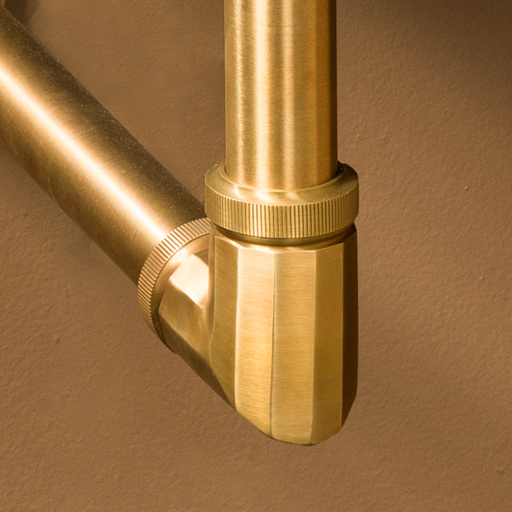 close up of Facet elbow fitting in aged brass