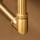 close up of Facet elbow fitting in aged brass