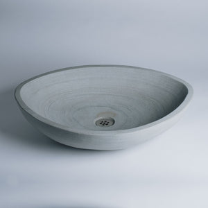 Akrotiri Vessel Sink is carved in grigio sandstone. This Akrotiri Vessel Sink is being sold as a second because of the naturally occurring brown spot next to the drain area. image 2 of 5