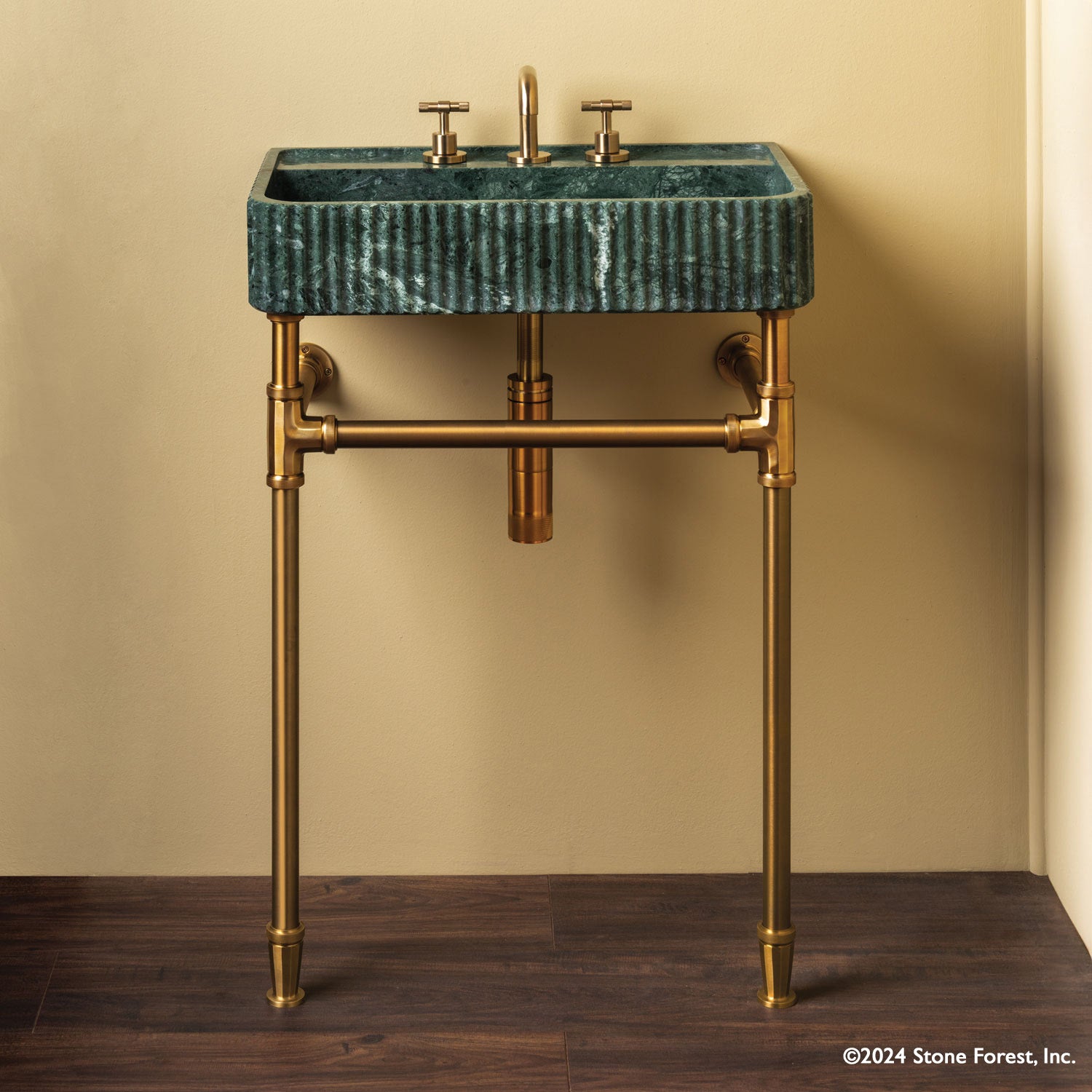 Fluted Lumbre Bath Sink carved from Verde Indio Marble on top of an Aged Brass  Elemental  Facet Crossbar Stand
