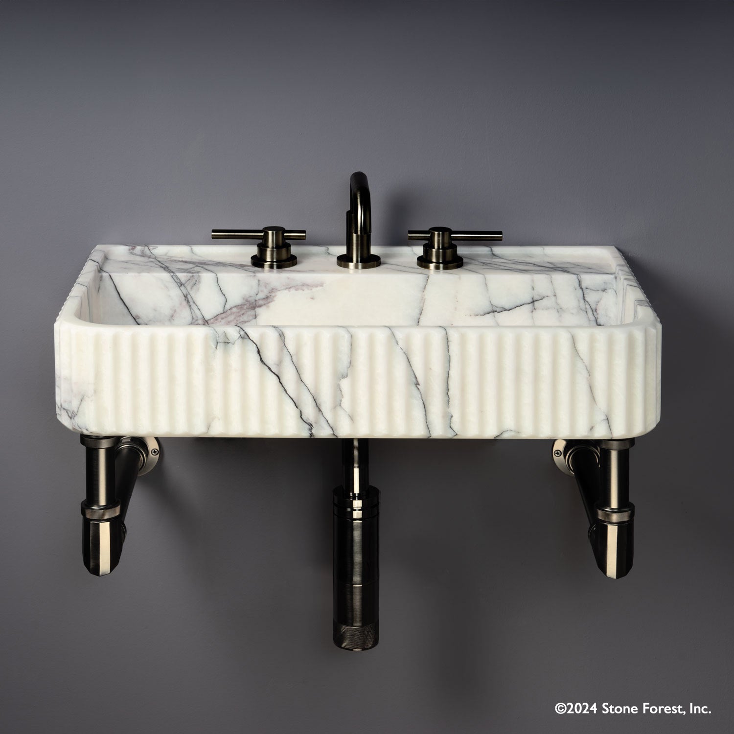 Fluted Lumbre Bath Sink carved from Viola Bianco Marble on an Elemental Facet Wall Unit in graphite